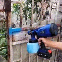 Cordless paint sprayer in use